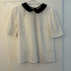 White shirt with black collar and gold buttons back